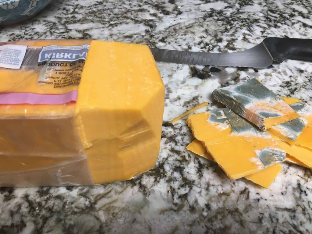 cut moldy cheese on countertop